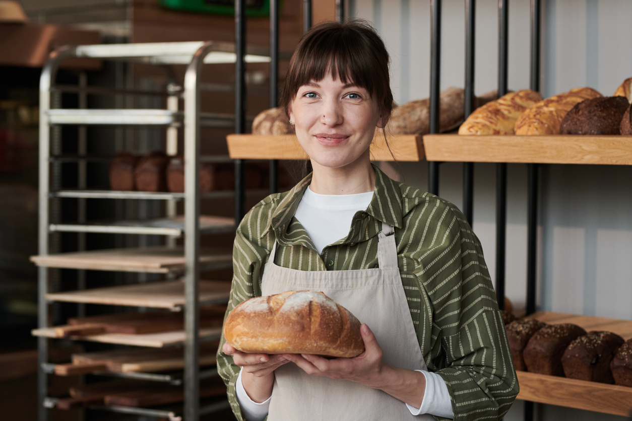 female baker holding bread
