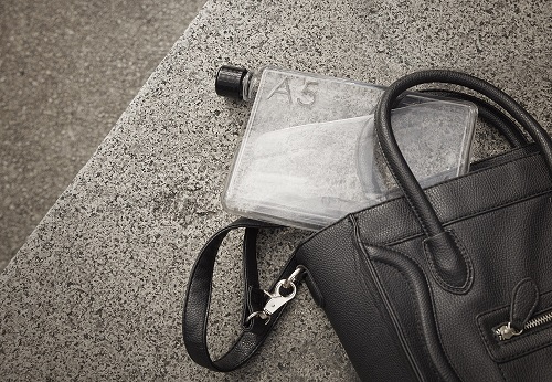 An A5 size waterbottle inside a handbag