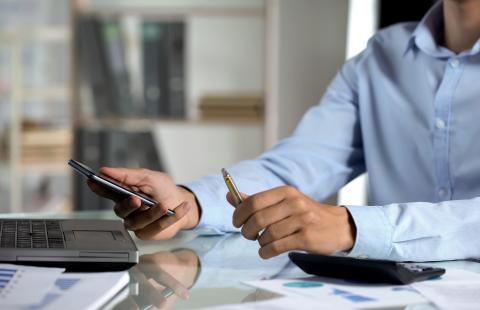 man using laptop and phone
