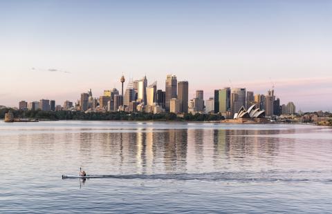 City of Sydney skylineA kayaker is passing by while the sunset is on the Sydney skyline. Central Business District and the Opera House is in the background.