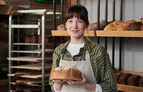 female baker holding bread